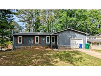 Charming single-story home with gray siding, brown shutters, and a well-maintained front yard at 1182 Demere Dr, Stone Mountain, GA 30083