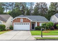 Charming brick home featuring a well-manicured lawn and an attached two-car garage in a beautiful neighborhood at 2319 Alnwick Dr, Duluth, GA 30096