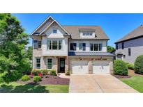 Charming two-story home featuring a mix of brick and shingle siding, plus an attached two car garage at 3910 Cameron Ct, Cumming, GA 30040