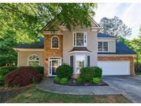Charming two-story home with stone accents, manicured landscaping, and a welcoming front entrance at 2687 Mountain Oaks Ct, Powder Springs, GA 30127