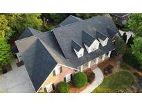 Aerial view of stunning home with a well manicured yard and mature shade trees at 328 Broadmoor Way, Mcdonough, GA 30253