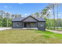 Charming single-story home with a covered porch and freshly landscaped front yard at 60 Wheeler Lake Path, Dallas, GA 30157