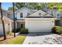 Charming townhome showcasing a two-car garage and well-maintained landscaping at 2000 Suttles Sw Dr, Atlanta, GA 30331