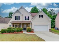 Charming two-story home with a well-manicured lawn and a two-car garage at 2725 Sedgeview Way, Buford, GA 30519