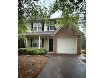 Two-story home featuring a brick accent, attached garage, and well-maintained landscaping at 4752 Browns Mill Ferry Rd, Lithonia, GA 30038