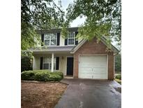 Charming two-story home featuring a brick accent wall and attached one car garage at 4752 Browns Mill Ferry Rd, Lithonia, GA 30038