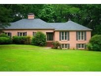 Charming one-story brick home with a well-maintained lawn and mature trees at 5346 Light Cir, Norcross, GA 30071