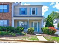 Charming two-story home featuring a welcoming front porch, tidy landscaping, and attractive curb appeal with blue shutters at 10900 Wittenridge Dr # L6, Alpharetta, GA 30022