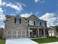 Charming two-story brick home with a two-car garage and well-manicured lawn in a desirable neighborhood at 1107 Kingston Hill Dr, Loganville, GA 30052