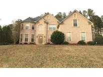 Elegant two-story brick home with a manicured lawn and a classic, inviting front entrance at 842 Treeline Dr, Conyers, GA 30016