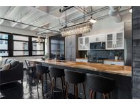 Modern kitchen featuring a large island with bar seating, stainless steel appliances, and ample counter space at 878 Peachtree St # 601, Atlanta, GA 30309
