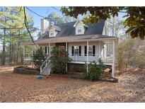 Charming exterior view of home featuring a full front porch and a neatly landscaped yard at 1645 Four Notch Rd, Carrollton, GA 30116