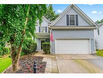 Charming two-story home with a two-car garage, an American flag, and a well-manicured front yard at 2865 Winter Rose Ct, Dunwoody, GA 30360