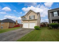 Inviting two-story home with a two-car garage, well-maintained lawn, and an ample driveway at 4015 Arch Pass, Cumming, GA 30040