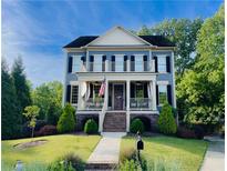 Charming two-story home with a welcoming front porch and second-story balcony at 1205 Renaissance Se Ct, Mableton, GA 30126