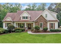 Charming home with stone accents, manicured lawn, and inviting front porch at 1825 Epperson Rd, Canton, GA 30115