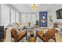 Bright living room with stylish furnishings, hardwood floors, and abundant natural light from large windows at 407 Pratt Se Dr # 1101, Atlanta, GA 30315