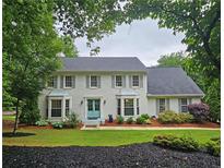 Charming two-story home with a landscaped front yard, gray shutters, and a bright blue front door at 1885 Dayron Trce, Marietta, GA 30062