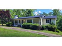 Charming single-story home featuring a welcoming front porch and lush landscaping at 294 A Donald Rd, Canton, GA 30114
