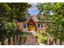 Charming brick home with a bright yellow front door and well-manicured landscaping at 588 Oakdale Ne Rd, Atlanta, GA 30307