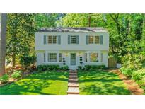 Charming two-story home with brick walkway and manicured lawn surrounded by mature trees at 770 Wellesley Nw Dr, Atlanta, GA 30305