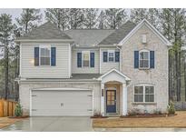 Charming two-story home featuring brick and siding exterior with blue shutters and a well-manicured lawn at 3652 Silvery Way, Powder Springs, GA 30127