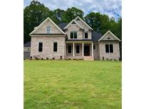 Charming brick home boasts lush green lawn and a classic architectural design with inviting front entrance at 5907 Sw Bunting Ln, Atlanta, GA 30331