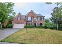 Beautiful two-story brick home with a well-manicured lawn and attached two-car garage at 1425 Turtle Dove Ln, Lawrenceville, GA 30043