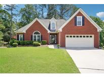 Charming brick home with well-maintained lawn and manicured shrubbery with two car garage at 1010 Capella Creek Way, Grayson, GA 30017