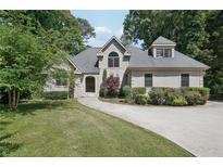 Charming home with well-manicured lawn, circular driveway, and inviting front entrance framed by mature trees at 1712 Shirley Sw St, Atlanta, GA 30310