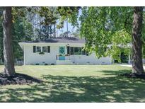 Charming single-story home featuring a well-maintained lawn and delightful blue front door at 317 Community Sw Dr, Mableton, GA 30126