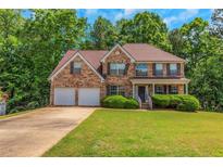 Charming two-story brick home with a well-manicured lawn and a two-car garage at 11354 Conner Ct, Hampton, GA 30228