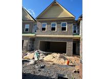 New construction townhome featuring a brick facade and an attached two-car garage at 3106 Marbella Cir # 3, Kennesaw, GA 30152