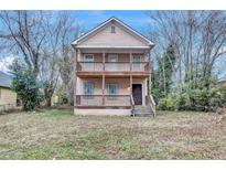 Two-story tan home with double front porches and a small, grassy front yard at 392 Vine St, Atlanta, GA 30314