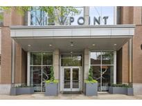 Elegant condo entrance with decorative planters and a welcoming covered entryway at 855 Peachtree Ne St # 3005, Atlanta, GA 30308