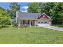 Charming single-Gathering home with well-manicured lawn, flowerbeds, and a two-car garage at 2416 Hurt Sw Rd, Marietta, GA 30008