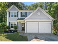 Charming two-story home features a well-manicured lawn and a two-car garage at 4104 Glenaire Nw Way, Acworth, GA 30101