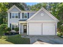 Charming two-story home with a two-car garage, well-maintained lawn, and classic architectural details at 4104 Glenaire Nw Way, Acworth, GA 30101