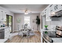 Eat-in kitchen features modern appliances, granite countertops, and hardwood floors at 10213 Tall Pine Ct, Villa Rica, GA 30180