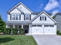Charming two-story home with a manicured lawn and a two-car garage, perfect for a Gathering at 566 Lullingstone Se Dr, Marietta, GA 30067