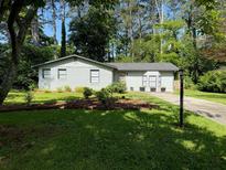 Charming single-story home with a well-maintained lawn and mature trees, offering great curb appeal at 910 Oriole Se Ln, Marietta, GA 30067