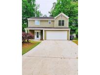 Charming two-story home featuring a spacious two-car garage and a well-manicured lawn at 2320 Glynmoore Dr, Lawrenceville, GA 30043