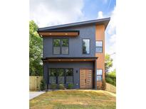 Modern two-story home showcasing a sleek exterior design and a well-manicured lawn at 104 Meldon Ave, Atlanta, GA 30315