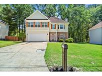 Charming two-story home featuring a well-maintained lawn and attached two-car garage at 740 Marcus Nyah Ct, Atlanta, GA 30349