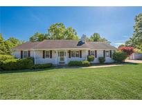 Charming single-story home with a well-manicured lawn, cozy front porch, and classic red shutters at 2492 Bermuda Dr, Loganville, GA 30052