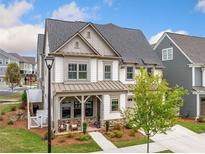 Charming two-story home featuring a welcoming front porch and manicured lawn at 1010 Fendley St, Woodstock, GA 30188