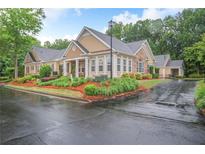 Inviting exterior with manicured landscaping, neutral color palette, and charming architectural details at 2595 Grapevine Cir, Cumming, GA 30041