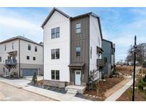 Charming two-story home with a modern design, light gray siding, and a well-manicured front yard at 3316 Stillwood Ln, Atlanta, GA 30354