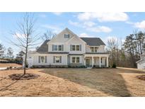 Stunning two-story home with grey siding, shutters and a well-manicured lawn at 2719 Byess Ct, Marietta, GA 30064