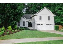 Charming home with a well-manicured lawn, lush landscaping, and a two-car garage, creating great curb appeal at 2986 Edenberry Nw Ln, Kennesaw, GA 30152